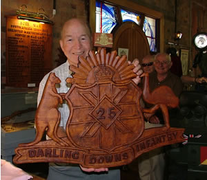 Ernie Blackwell presents his new carving to the museum.